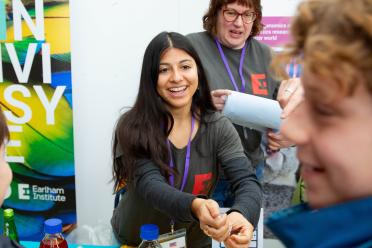 EI staff smiling and looking at members of the public at the Norwich Science Festival 2024