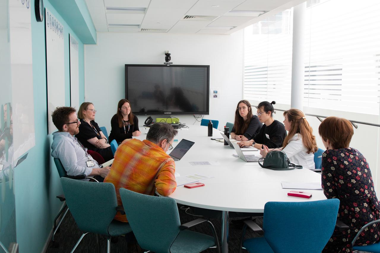 Colleagues from the CellGen ISP discussing around a table during a programme meeting