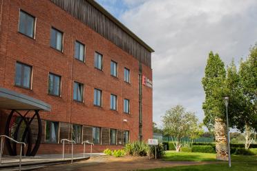 The exterior of the Earlham Institute building on a sunny day