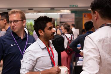 PhD researcher Yash Bancil networking during the symposium