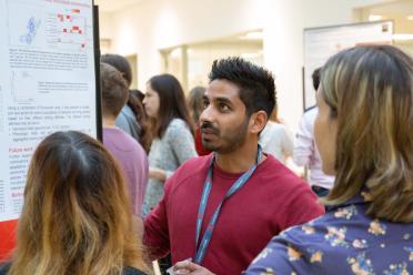 PhD researcher Yash Bancil networking during the symposium