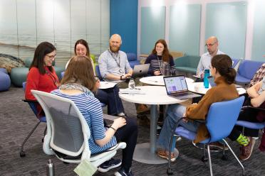 Colleagues sitting around a table during a single-cell journal club