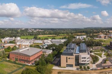 Aerial photo of the Earlham Institute building next to the Quadram Institute building on the Norwich Research Park