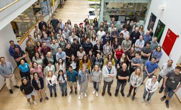 All staff photo in the atrium of our building